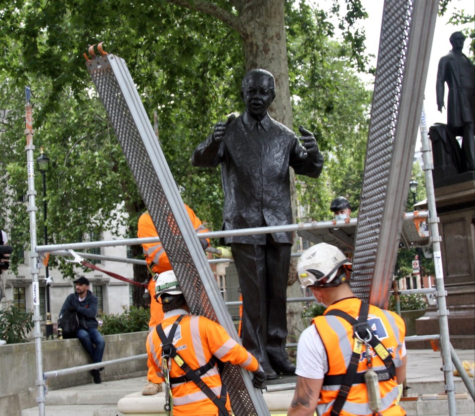 The statue of Nelson Mandela in London's Parliament Square is boarded up