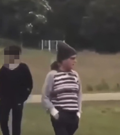 The woman was wearing a dark beanie, black trousers and a striped jumper