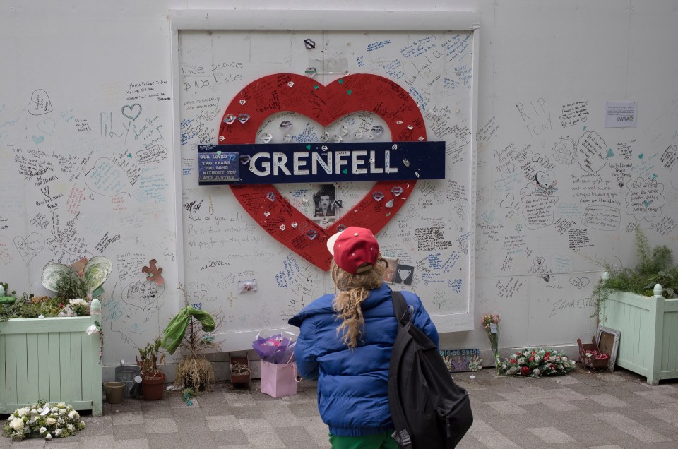 A woman reads the messages left for those who died in the blaze