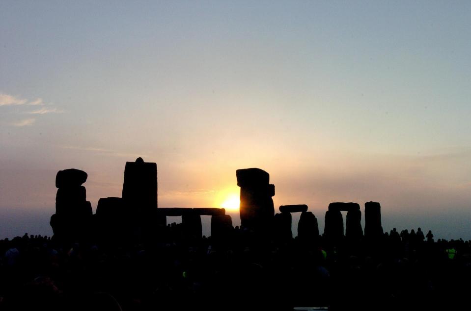 The sun rises over Stonhenge in Wiltshire at dawn where more than 20,000 people gathered to mark the summer solstice at the prehistoric site