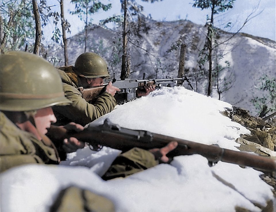 Two American troopers take aim on a snow-covered mountain