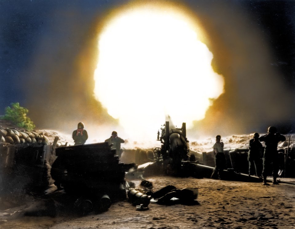 US artillery crew fires a Howitzer toward enemy lines