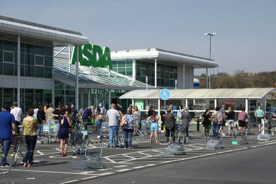 Asda shoppers pictured queuing 2m apart outside of one store