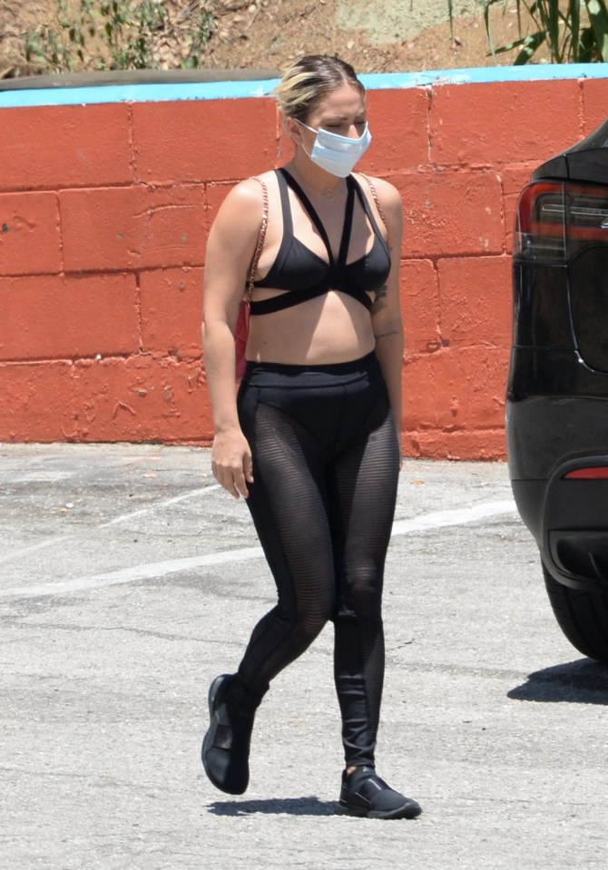 Lady Gaga wears a strappy cropped top and leggings for a stroll with boyfriend Michale Polansky