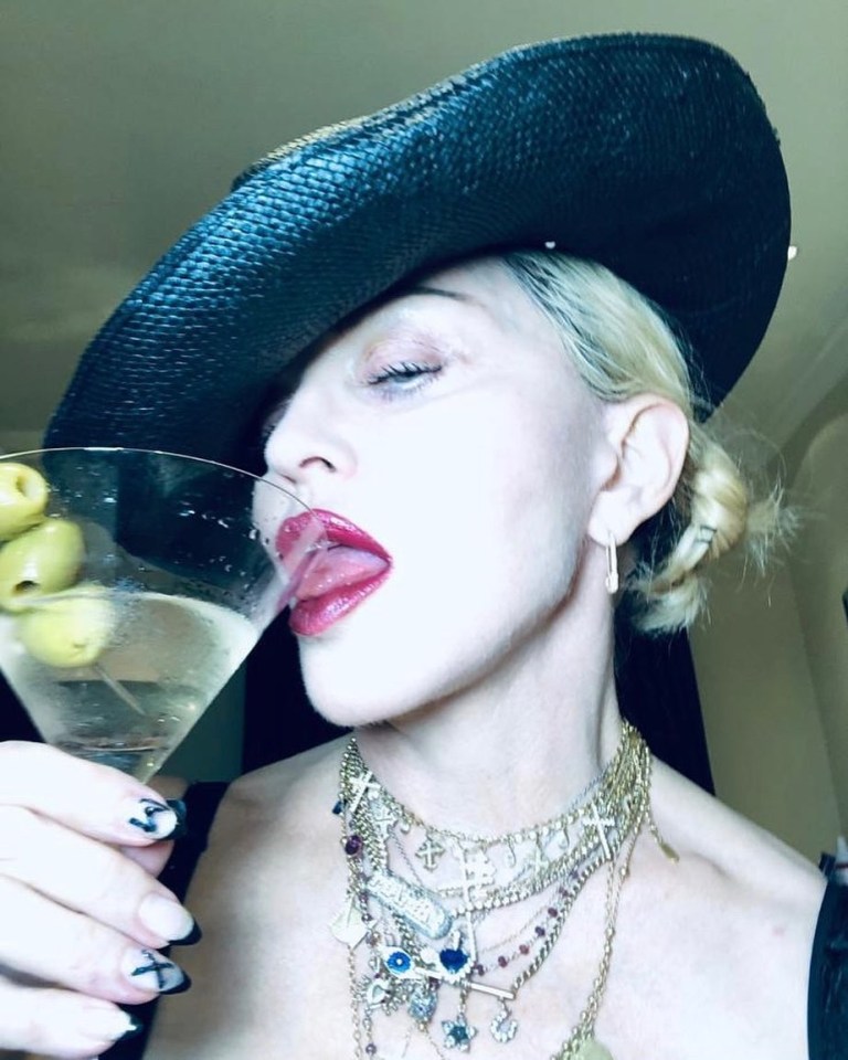 For Madona, 61, accessories are everything, and the singer enjoys a quarantine cocktail in lockdown