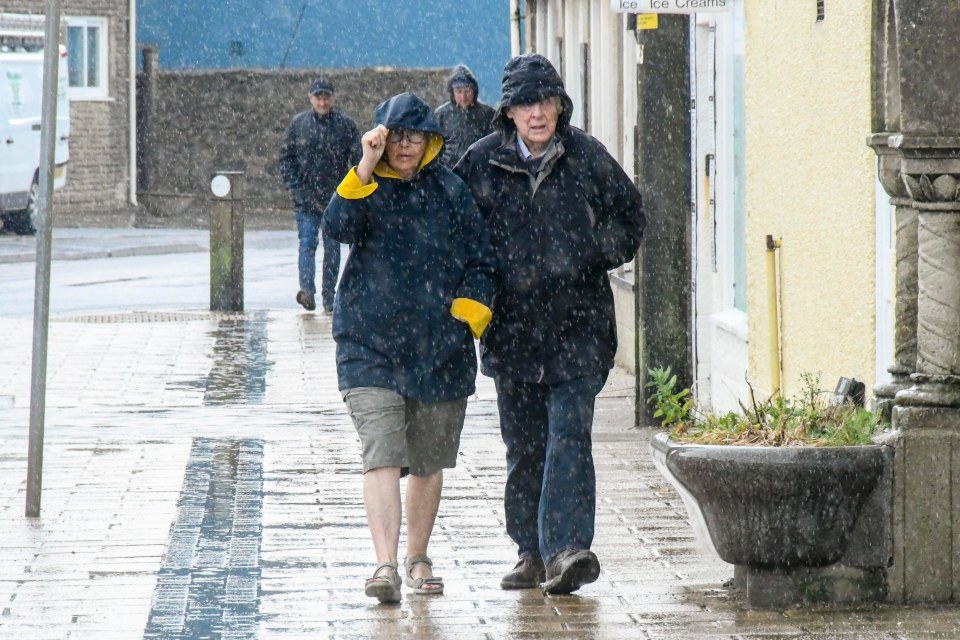  A couple walk in the rain in Dorset