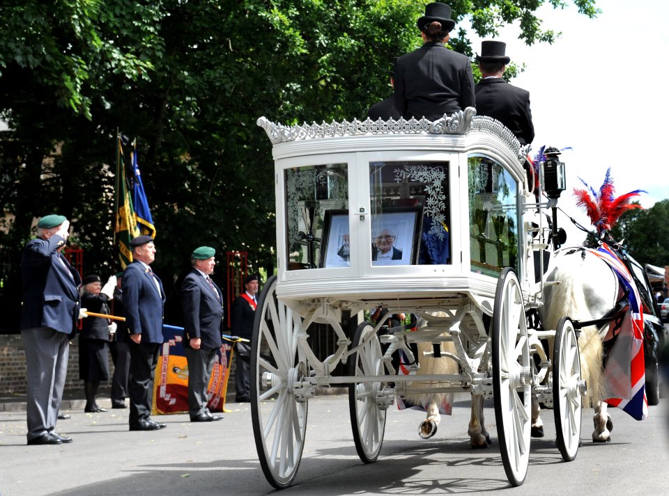  At his funeral today, Normandy veteran Derek Coyle's coffin was transported on a horse-drawn carriage as a guard of honour paid  lined up to pay tribute