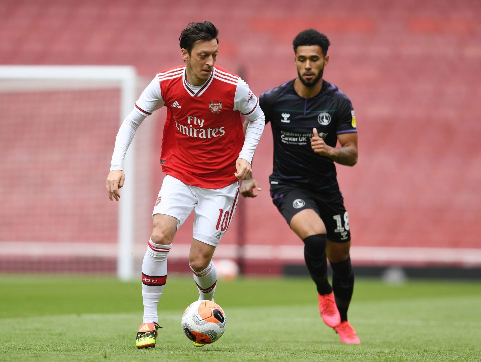  Mesut Ozil keeps the ball from Andre Green