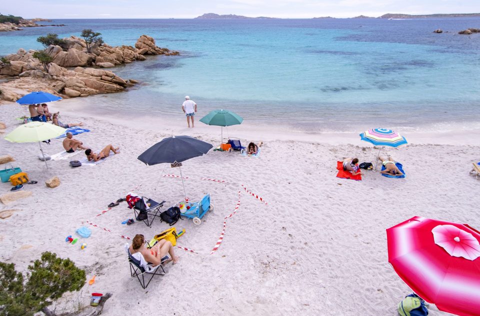  Tourists on beaches in Sardinia have been trying to respect the rules of social distancing