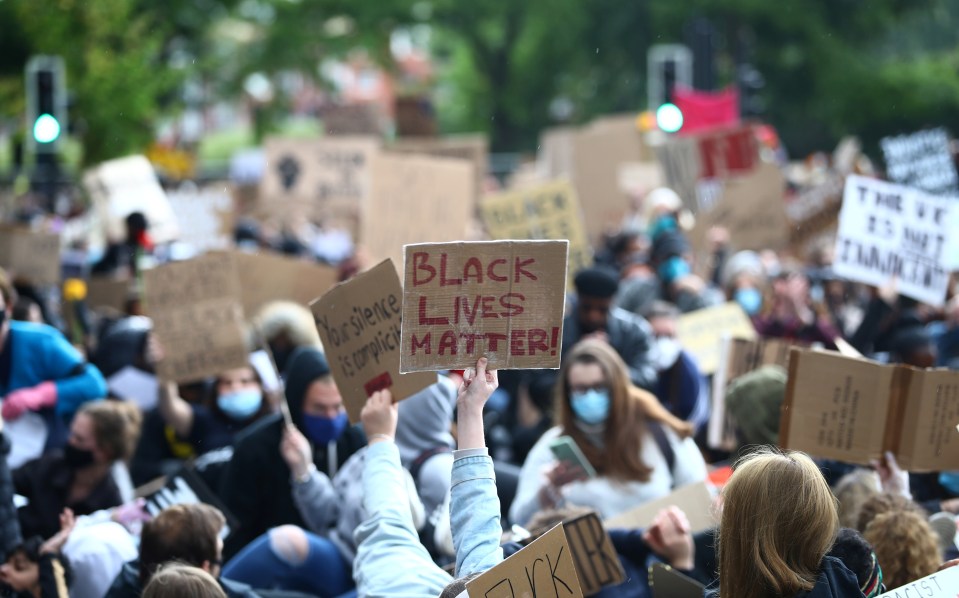  The protesters hold up signs in London on Sunday