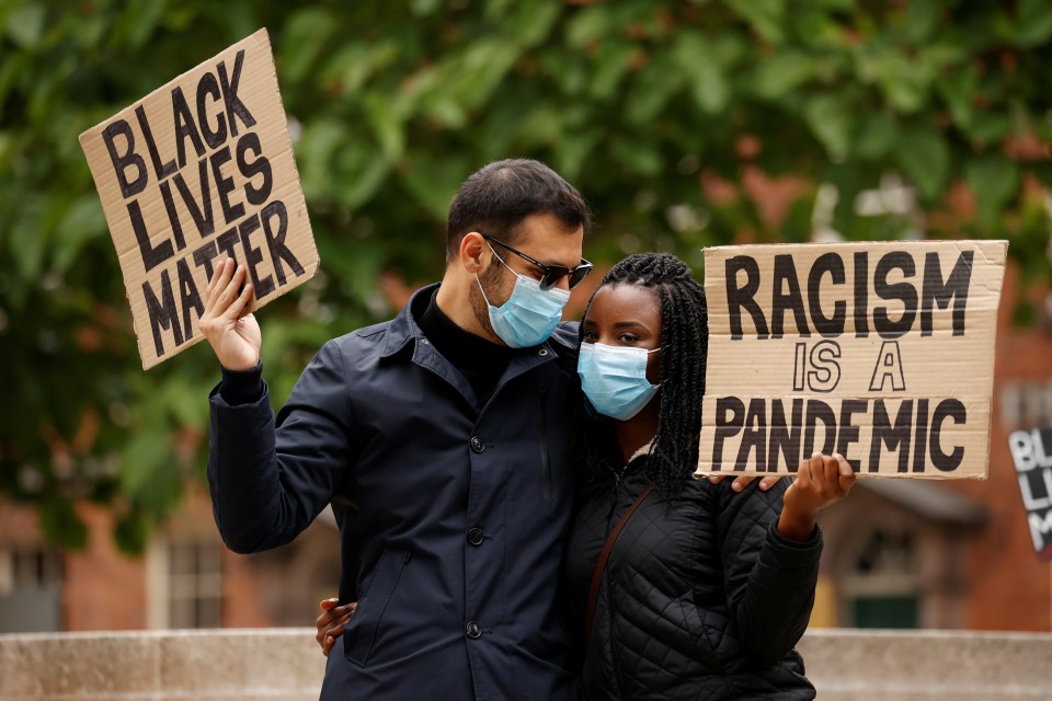  A couple embrace at the march against racism and police brutality on Sunday