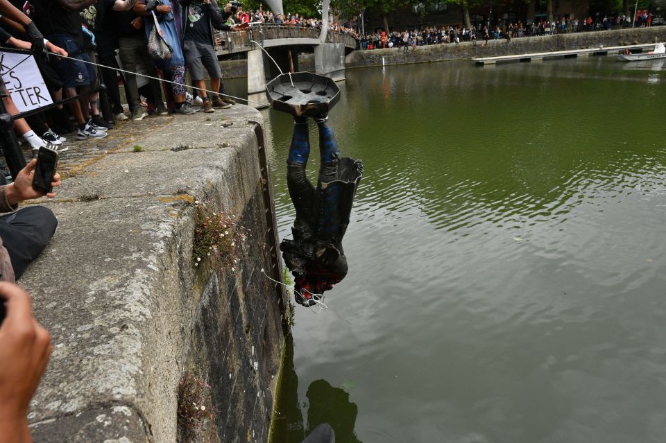 Protestors settled years of debate by rolling it down the hill and into the water