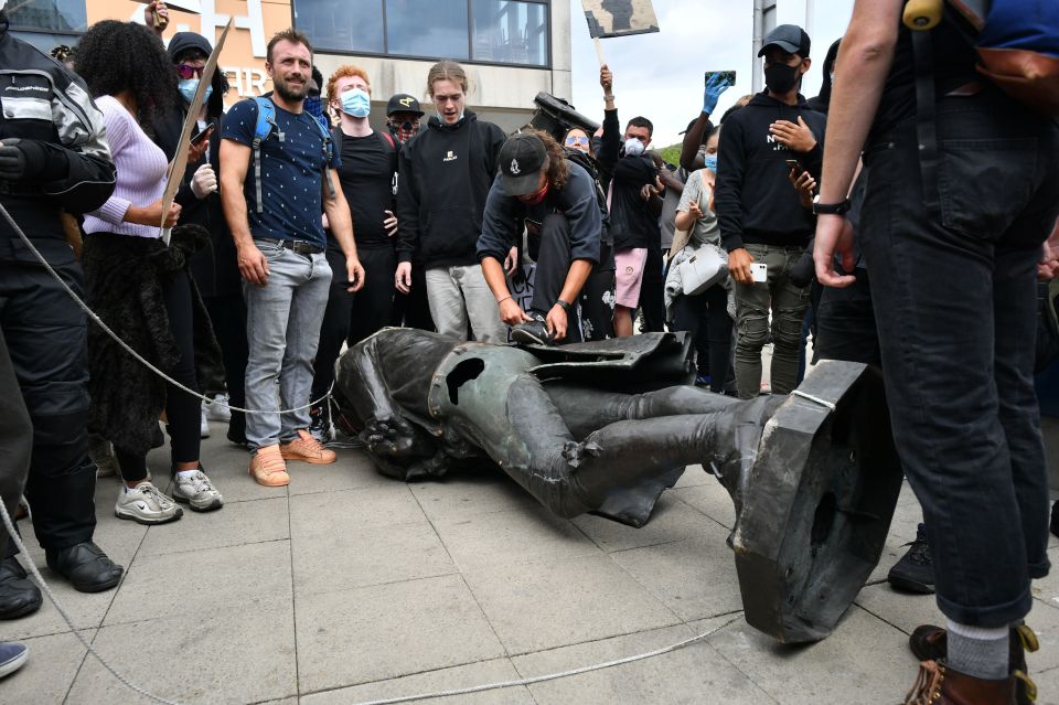 The statue of Edward Colston was beaten with poles after it had been pulled to the floor