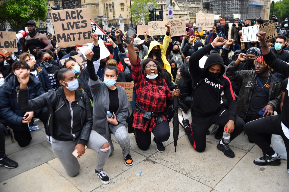  Demonstrators take a knee in Parliament Square during a Black Lives Matter protest in London