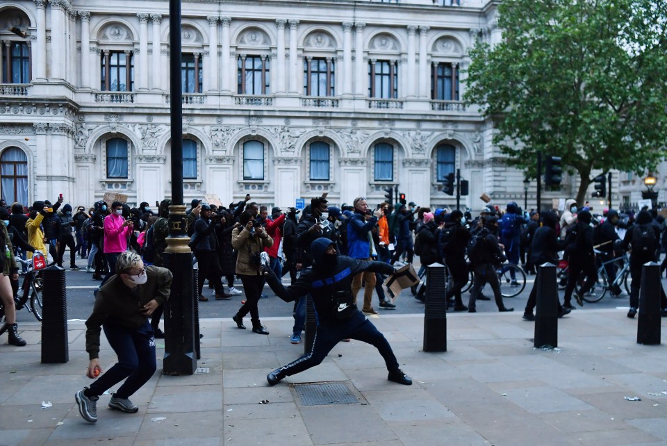 One man is seen tossing an object during today's protest