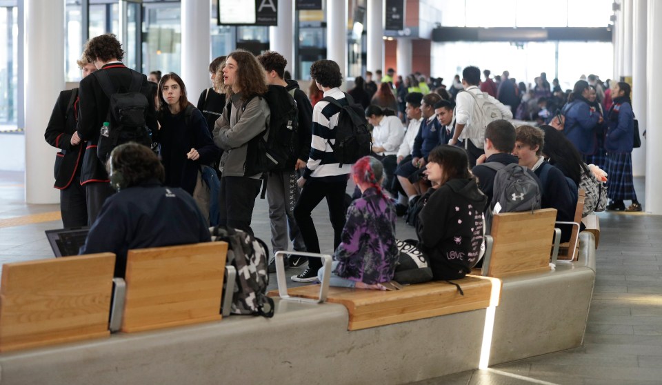  Commuters wait for transport at a bus interchange in Christchurch, New Zealand