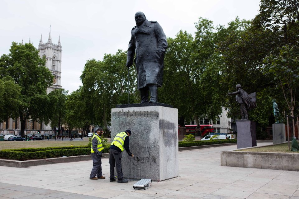  Workers clean off the graffiti this morning