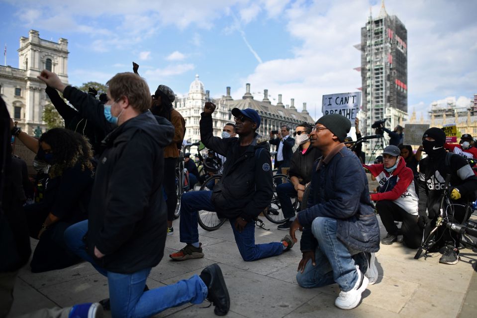  Demonstrators 'take the knee' during a protest in front of a statue of Nelson Mandela in London