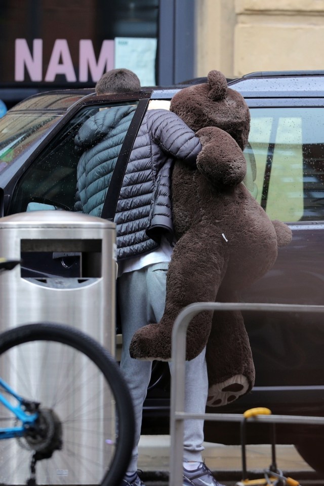  A pal could be seen loading up a giant teddy bear