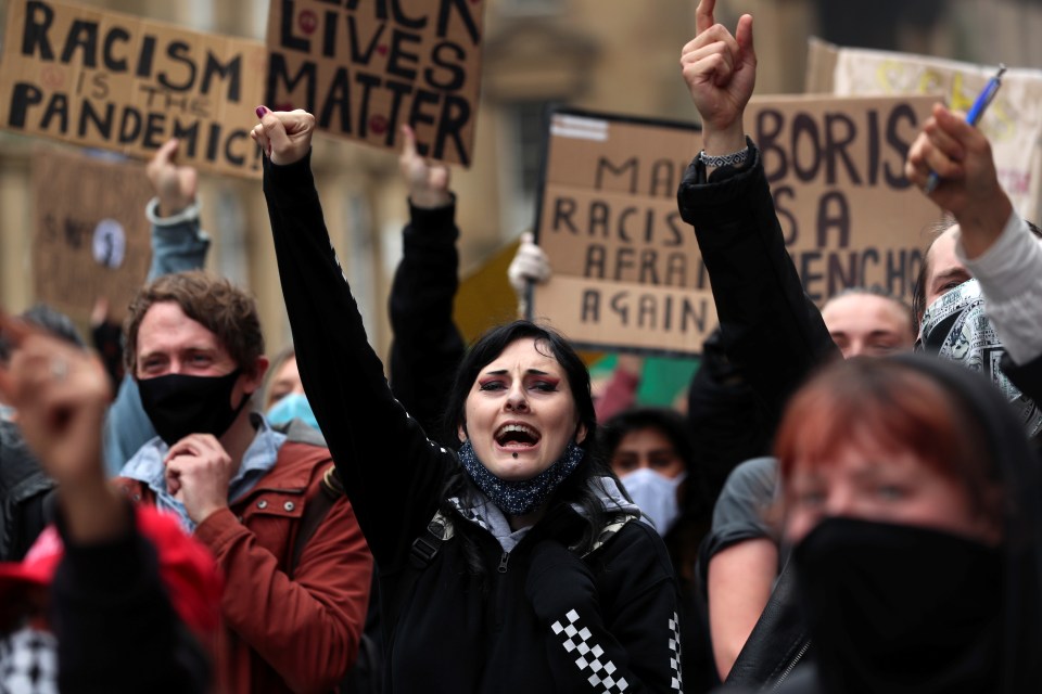 Demonstrators gesture as they attend a Black Lives Matter protest in Newcastle on Saturday