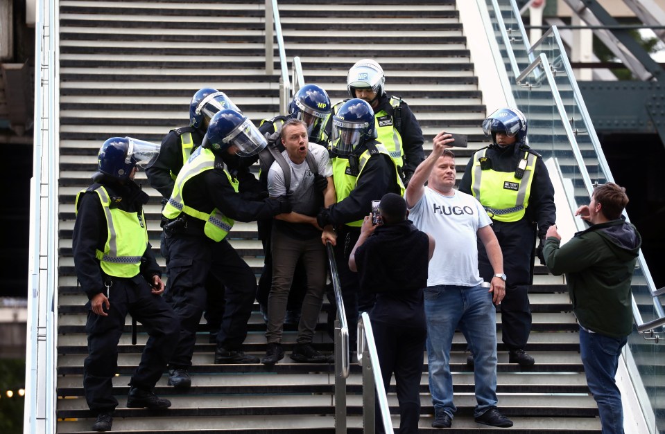 A man thought to be with the counter BLM demo is detained by police