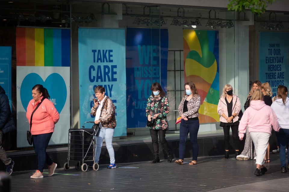 Customers seen waiting in face masks in Liverpool