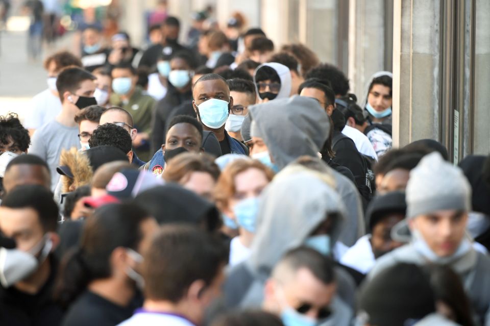 People queuing outside the Nike Town store at Oxford Circus as non-essential shops were opened