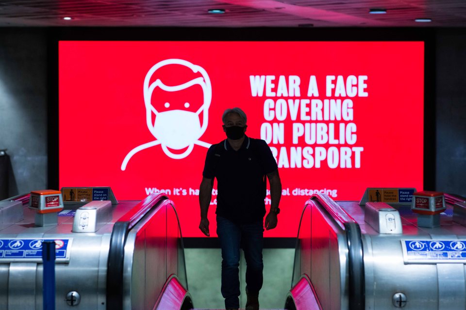 Signs were put up and projected around Tube stations reminding passengers to wear a face covering