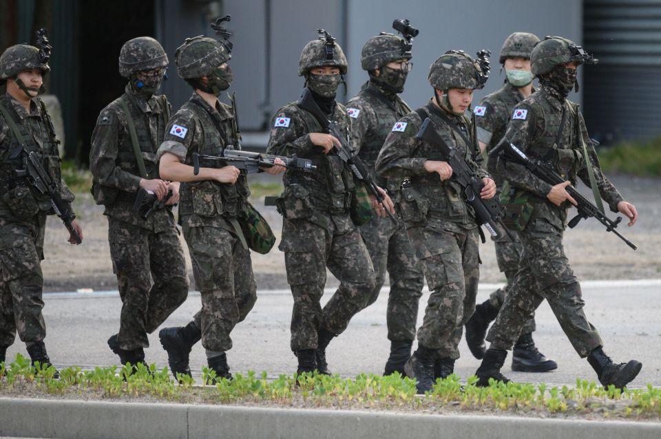 South Korean soldiers walk along a road in Inje county near the DMZ