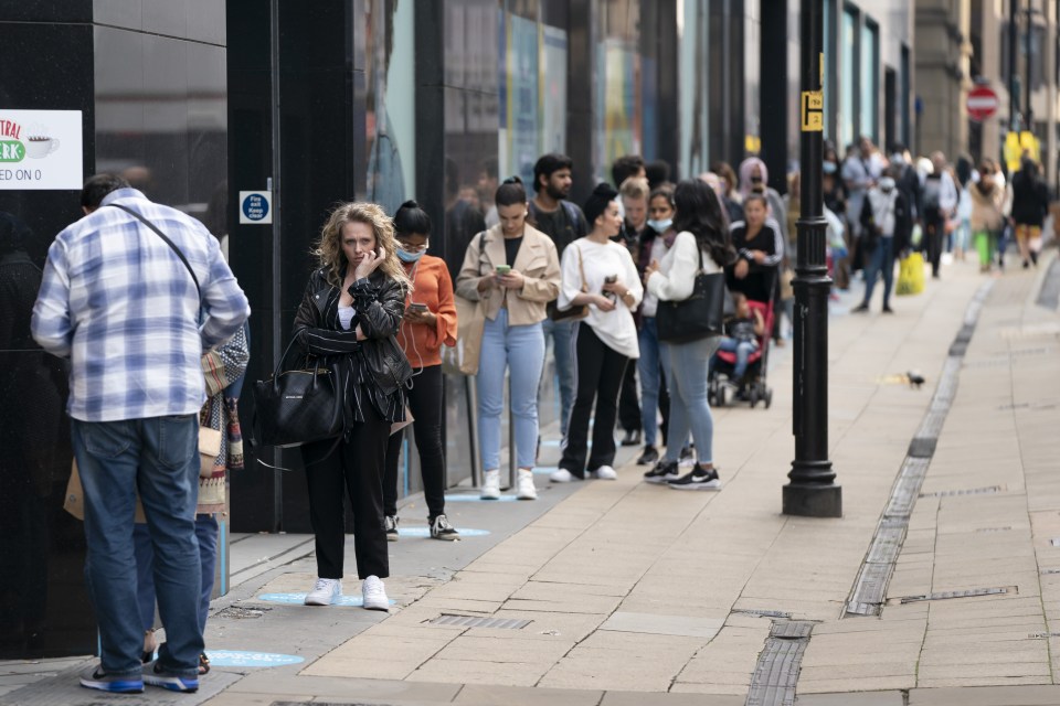 People queue outside a Primark store in central Manchester