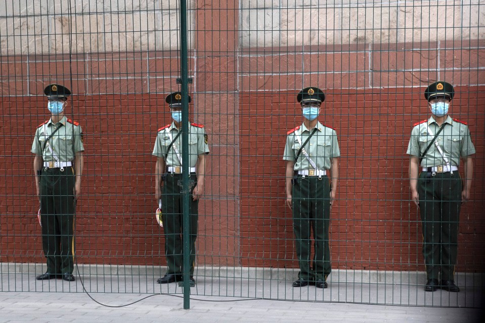 Chinese paramilitary policemen stand guard outside the Indian embassy in Beijing