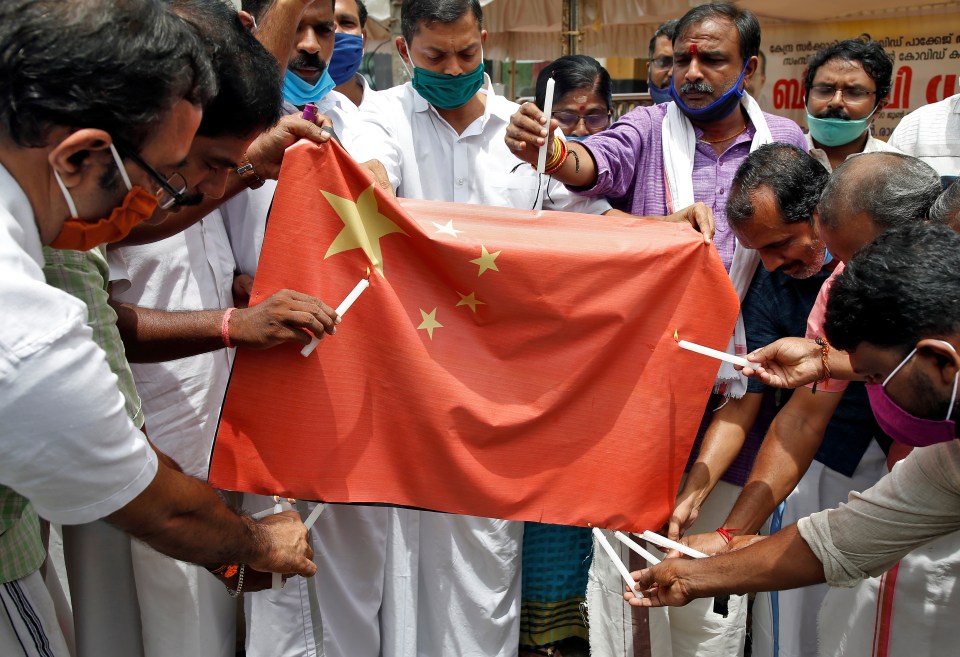 Protesters burn the Chinese national flag in Kochi