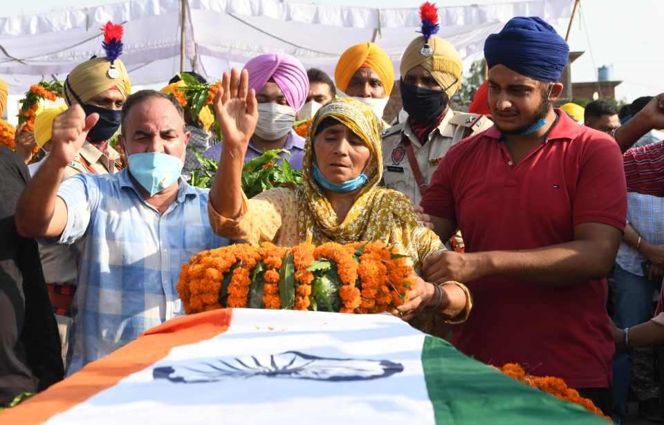 Wreaths of flowers are laid on the coffin of soldier Satnam Singh