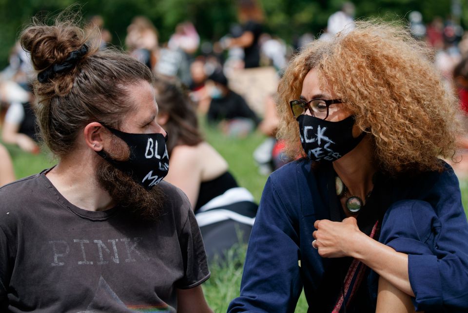 Two protestors in Leeds with masks reading 'Black Lives Matter'