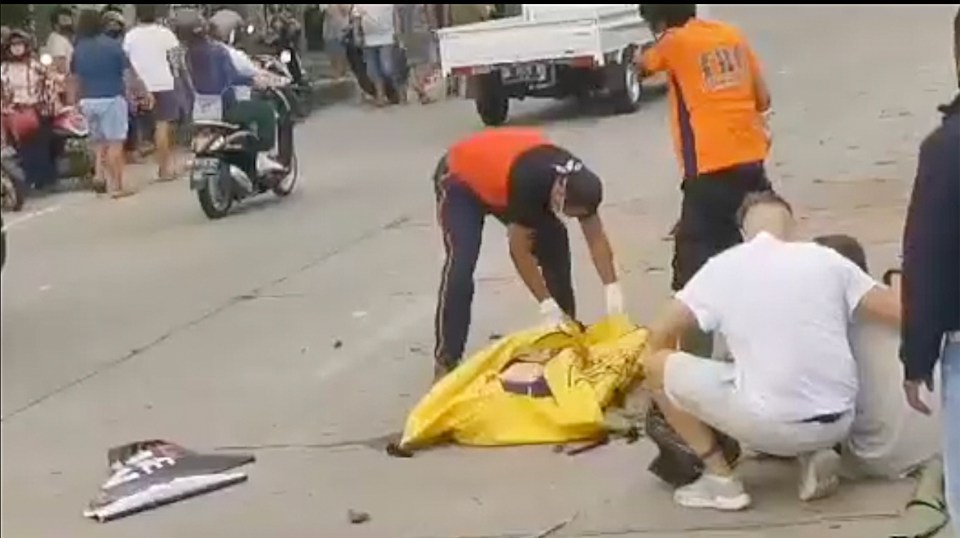 The scene of the accident in Bali, the young woman's boyfriend can be seen being comforted