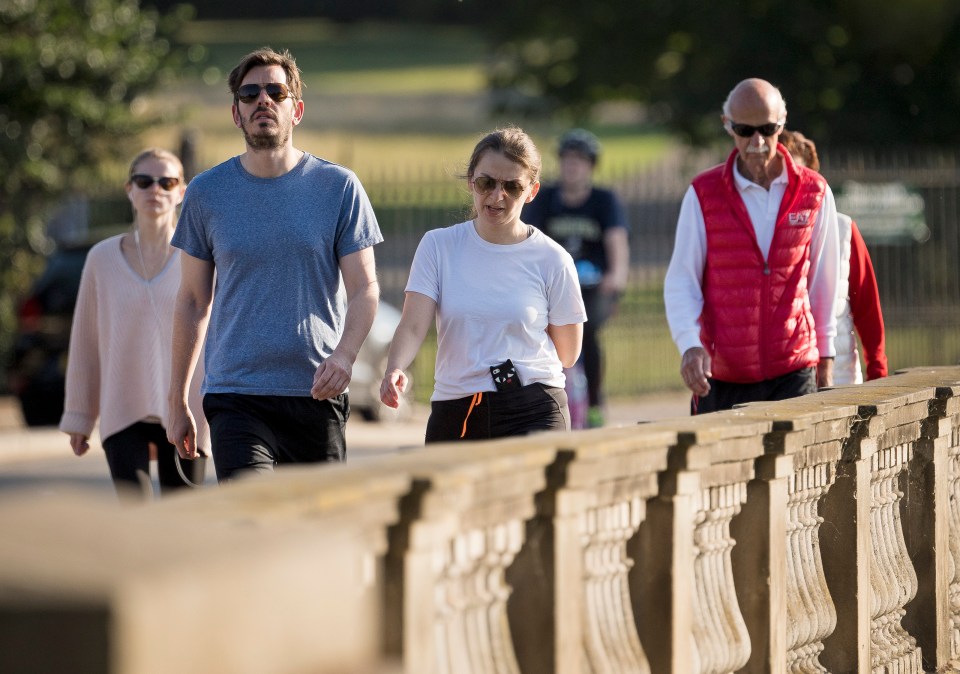 Walkers out for an early morning stroll in Hyde Park in central London