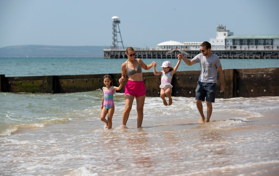 Gabor and Liene Bule enjoy a day out at the beach in Bournemouth with their children Laura, seven, and Dana, five