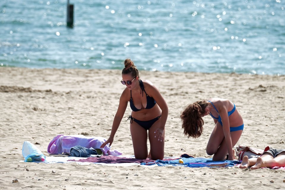 Two women get some sun at Bournemouth beach on Tuesday