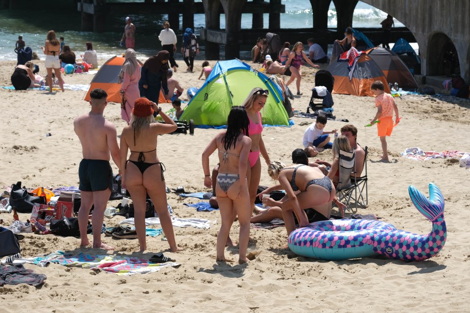 Beachgoers on the shore in Bournemouth