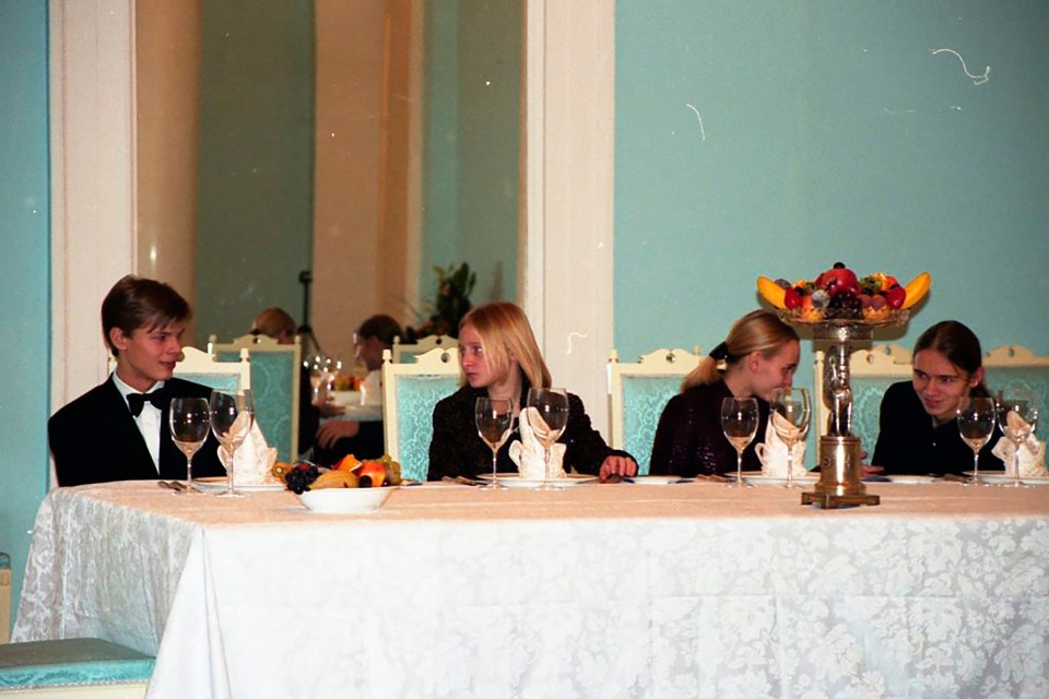 The Putin and Pugachev children at a long dining table