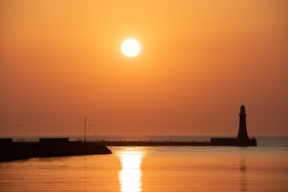  The sun rises at Roker Pier in Sunderland ahead of a scorching 32C day