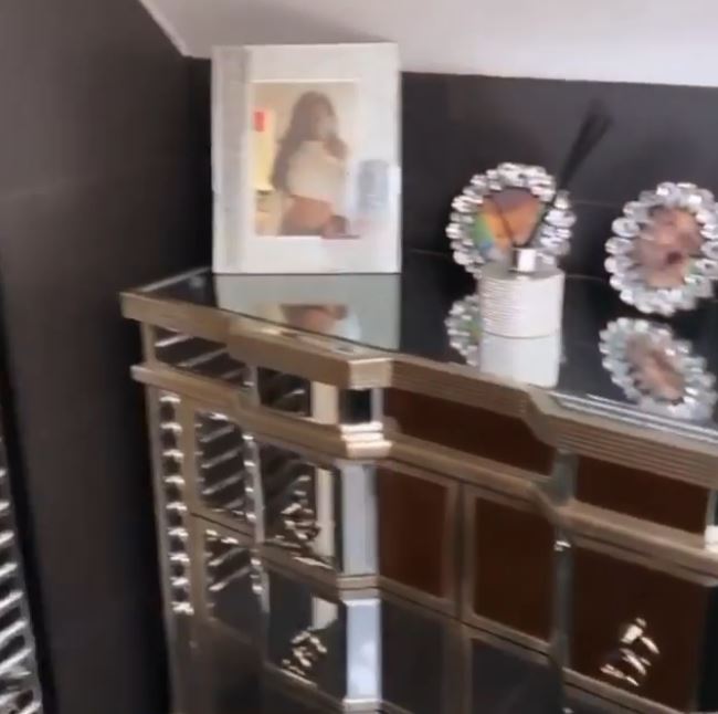  Mirrored cabinets boast framed photos of Lauren and scent diffusers