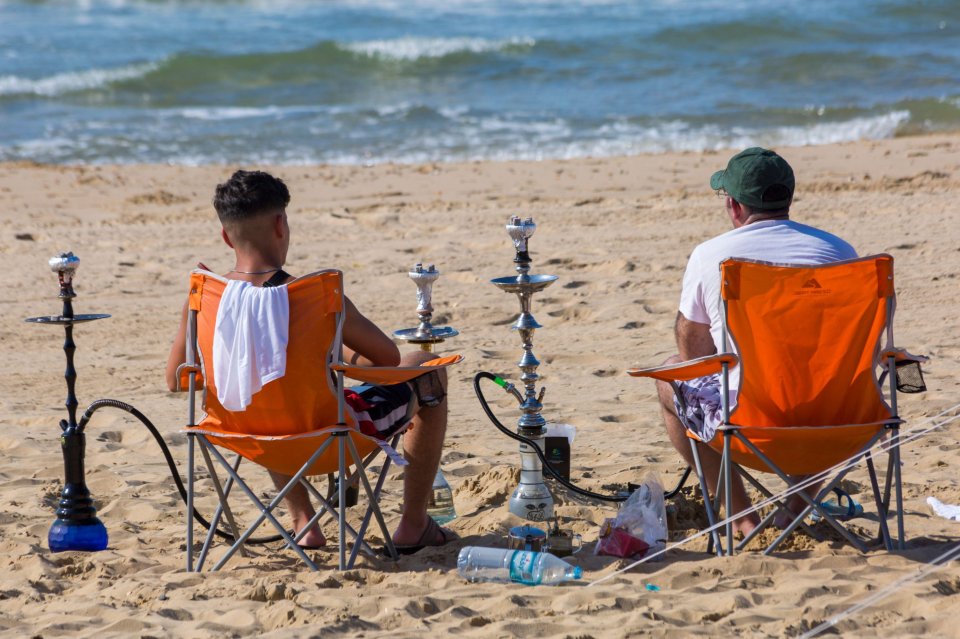  Pals sit on the beach at Bournemouth on Wednesday as temperatures continue to climb