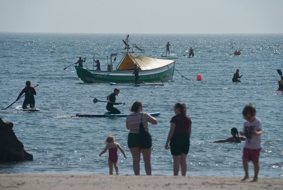 People enjoy the sunshine at Cullercoats Bay, Tyne and Wear on Wednesday