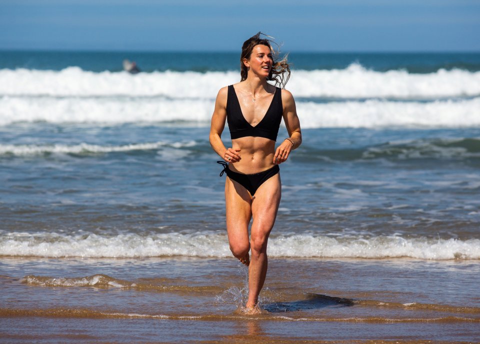  Lucy Campbell, 24, emerges from the sea at Woolacombe beach in Devon on Wednesday