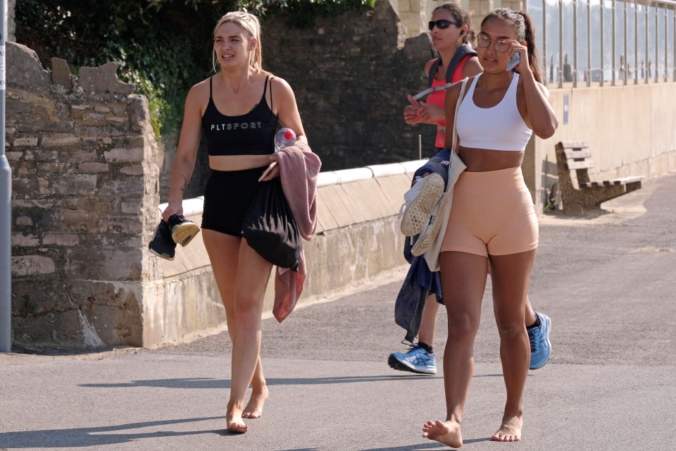  Beachgoers walk towards the shore at Branksome