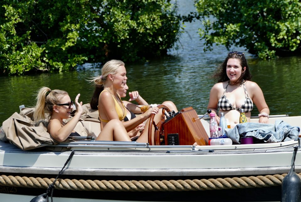  Friends lap up the sun on a boat on the River Thames at Henley