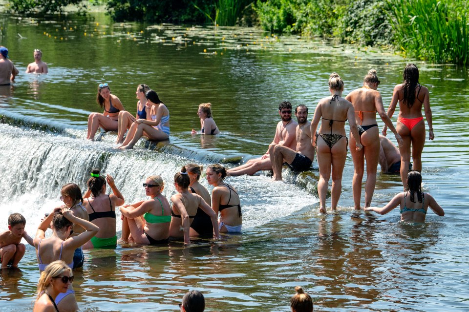  People enjoy the water at Warleigh Weir on the river Avon near Bath