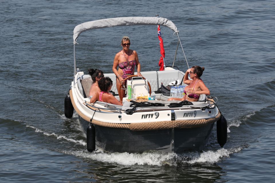  Friends soak up the warm weather on a boat on the River Thames in Henley