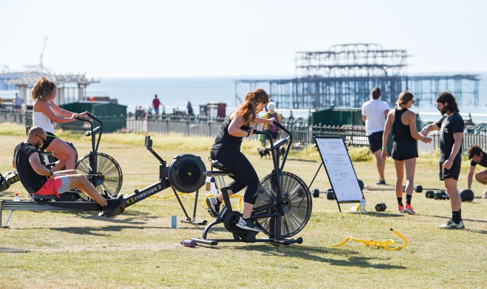 Members of the Vault 164 gym workout outside on Hove Lawns, Brighton